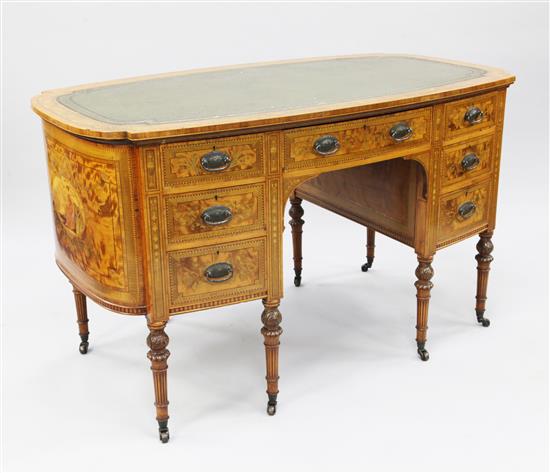 A late Victorian oval satinwood and marquetry inlaid writing desk, by Maple & Co, W.4ft 3in.